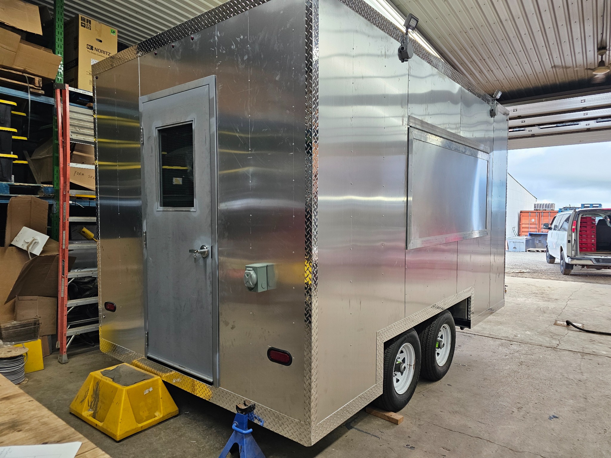 Trailer exterior with silver walls inside the workshop