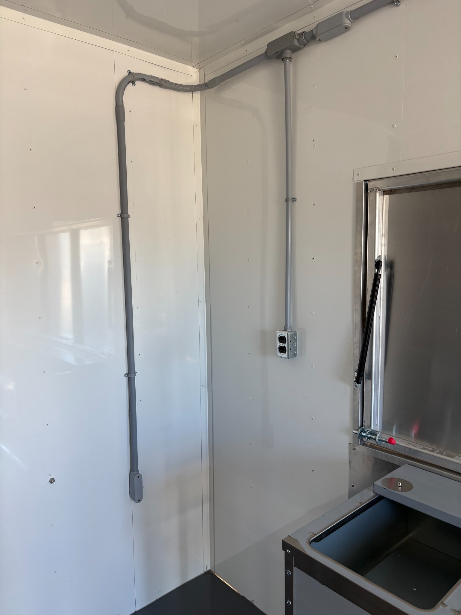 Electrical conduit and outlets installed on an interior wall