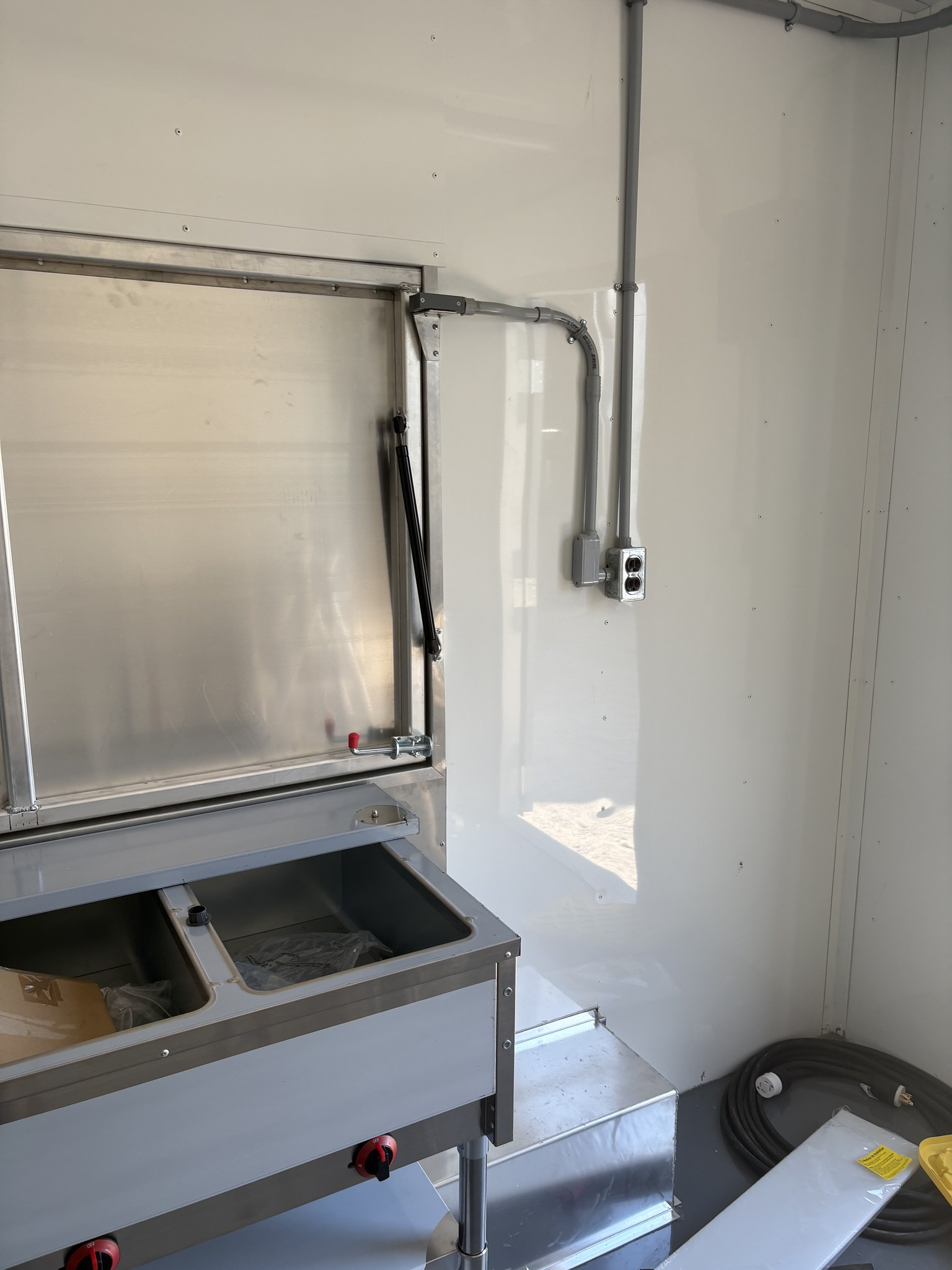 Steam table and electrical outlets beside the serving window