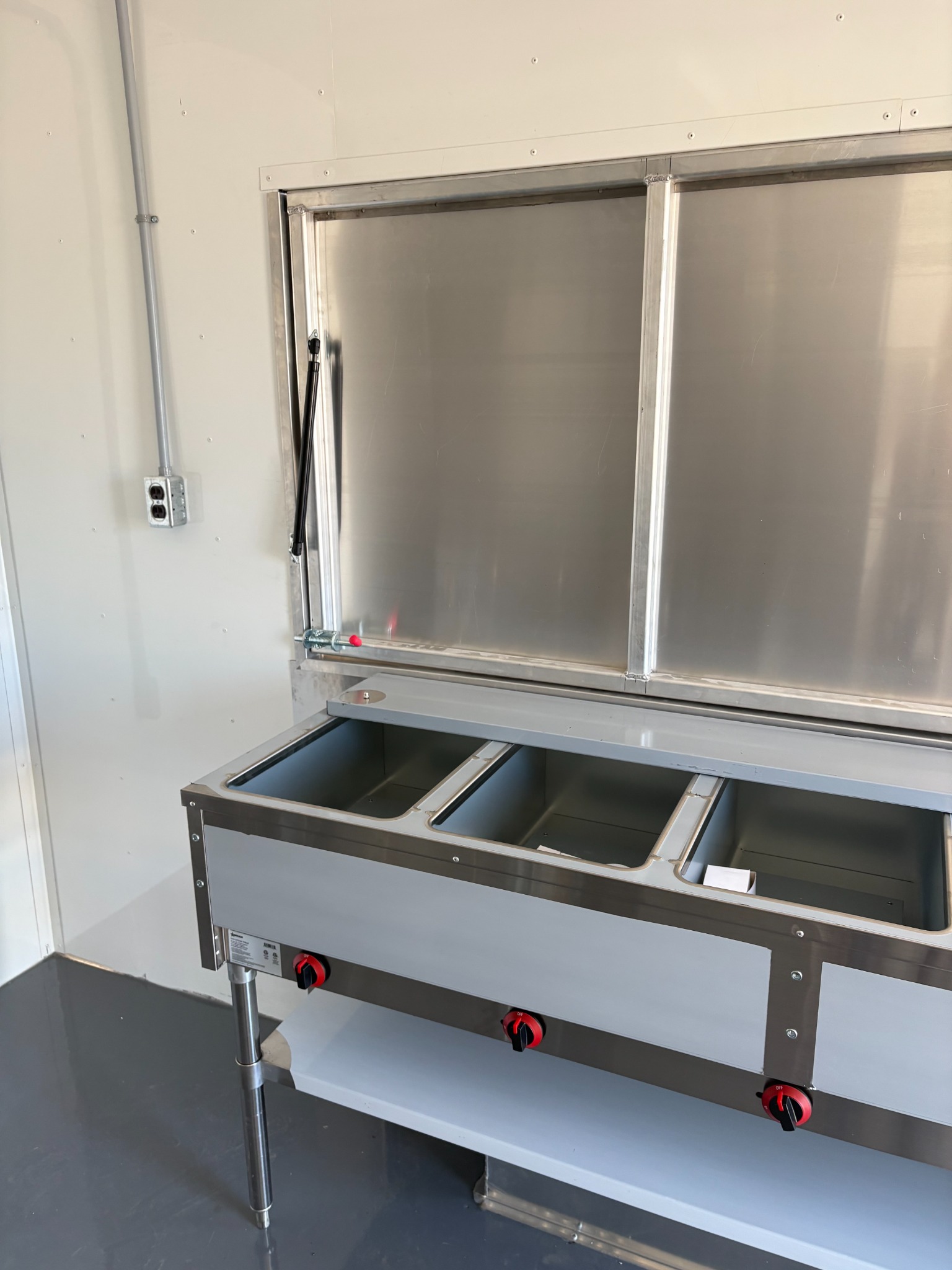 Stainless steam table below the serving window